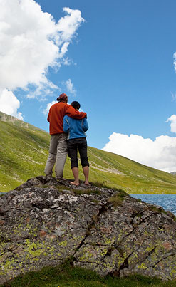 image of couple standing on a rock